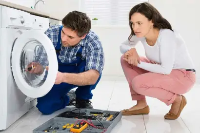 Technician performing washer diagnosis and repair